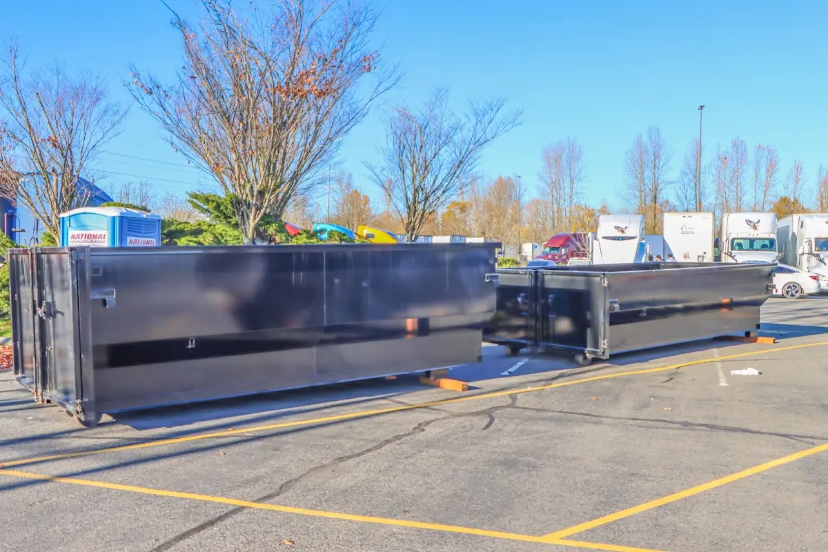 Professional dumpster rental service with roll-off container on residential driveway in Sioux City